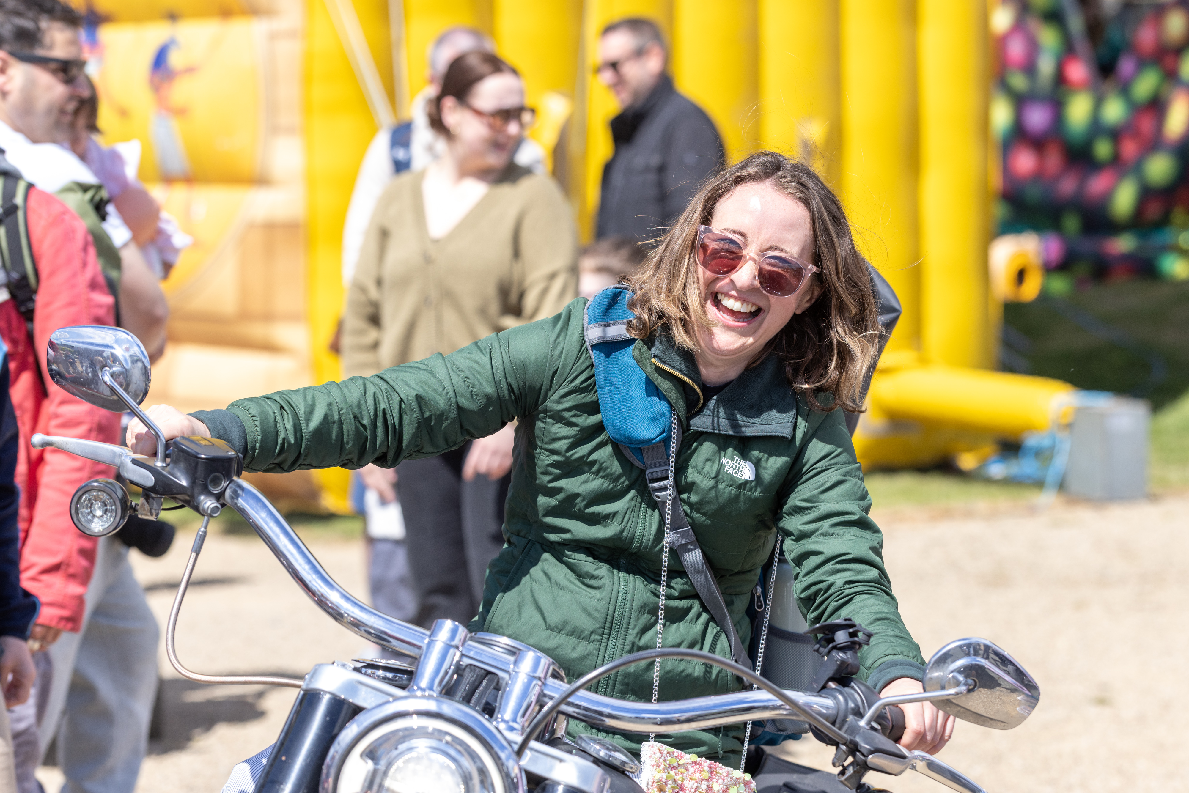 Person smiling on motorbike.